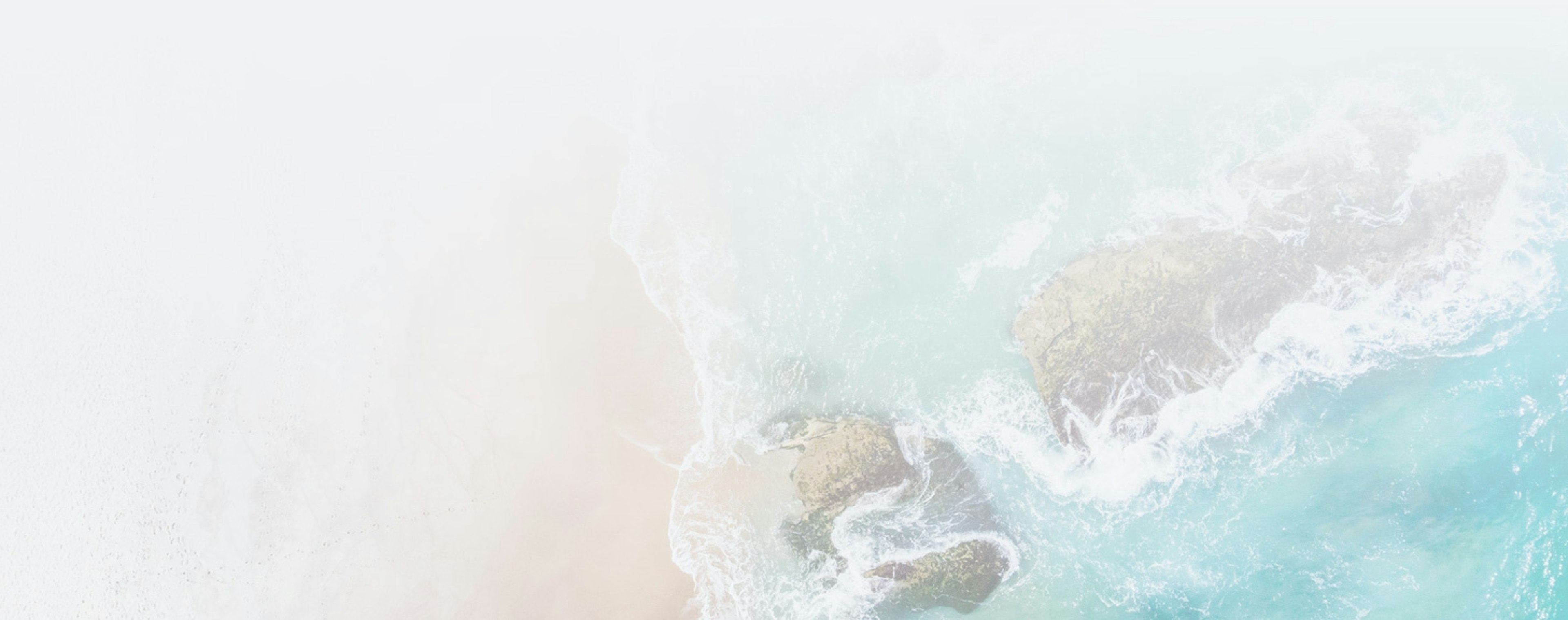 beach with waves crashing on shore from a bird eye view